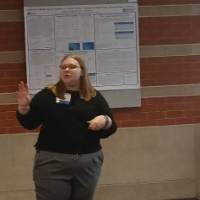 Loren Robar talking about her poster presentation to a female observer